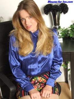 Lottie Lalay wears a blue satin 80s highnecked blouse